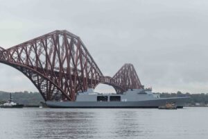 HMS Venturer being towed under the iconic Forth Railway Bridge just north of the city of Edinburgh. Image: Peter Devlin and Tim Edgeler/Babcock International