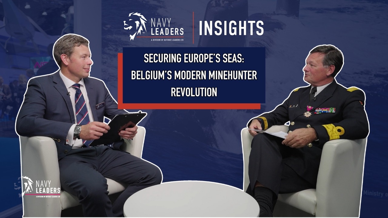 Video thumbnail for "Securing Europe’s Seas: Belgium’s Modern Minehunter Revolution". The image features two men seated facing each other. One man is in a suit whilst the other is naval uniform.