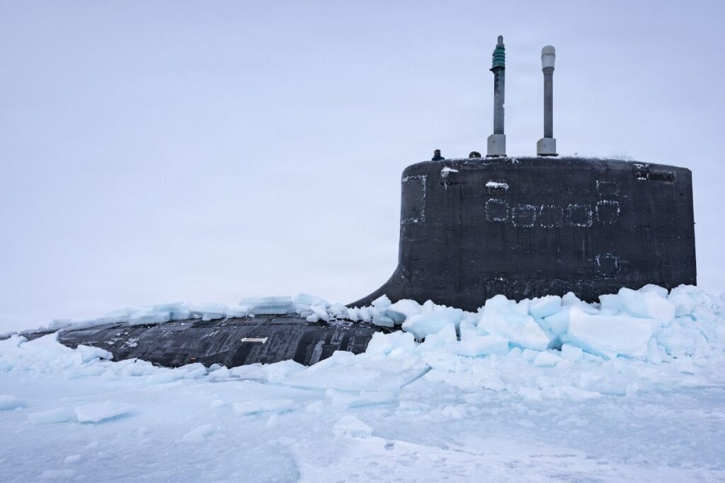 Virginia-class fast-attack submarine USS Delaware emerging from the ice after performing a vertical surfacing during Operation Ice Camp 2026.