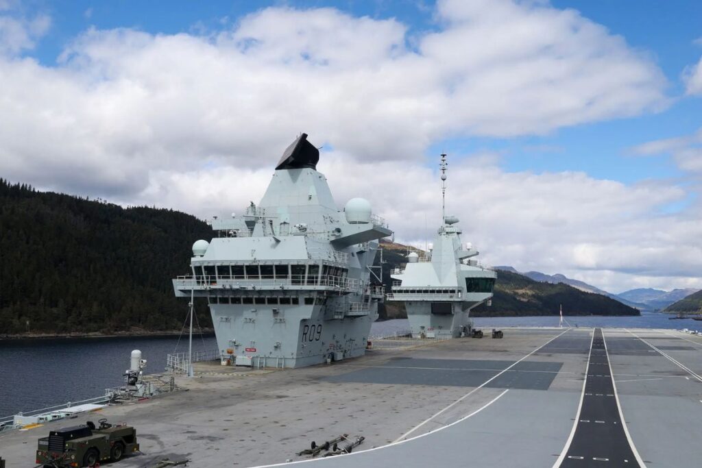 Royal Navy flagship HMS Prince Of Wales sailing down Loch Long en route towards her latest deployment.
