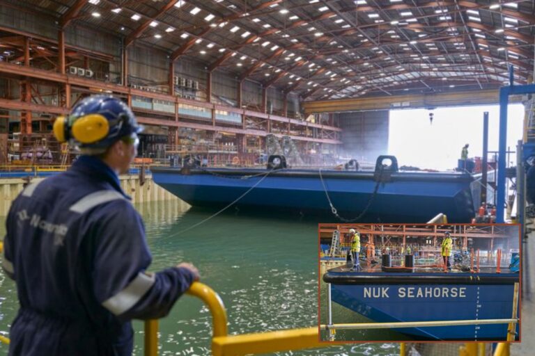 The purpose-built 85-metre barge, NUK Seahorse, being guided into position at the Appledore shipyard in Devon.