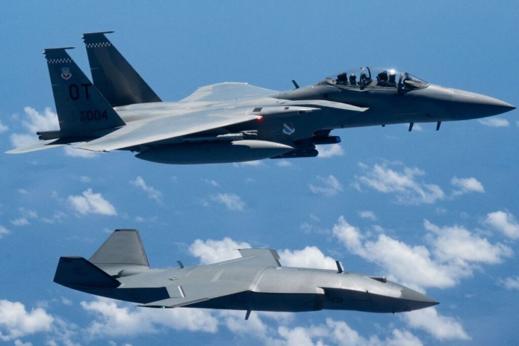 A U.S. Air Force F-15EX Eagle II and an MQ-28 Ghost Bat flying in formation over the Philippine Sea during Exercise Valiant Shield 2026.