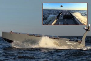 The MV11 USV under way (main picture) and releasing a smaller UAS (inset).