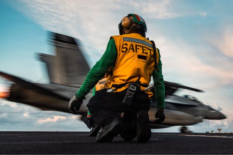 A catapult safety observer watches an F/A-18 Super Hornet launching from USS Gerald R. Ford in the Caribbean in November 2025.