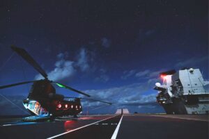 An RAF Chinook on the deck of HMS Queen Elizabeth at night on Exercise Hathi Pol.
