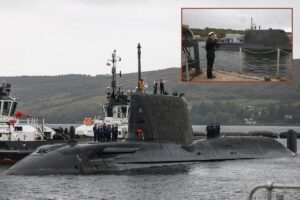 HMS Agamemnon, the sixth Royal Navy Astute-class hunter-killer submarine, is saluted (inset) as she arrives at her homeport, HMNB Clyde.