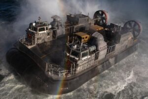 Landing Craft Air Cushion (LCAC) 104, attached to Assault Craft Unit 4, approaches the Wasp-class amphibious assault ship USS Kearsarge; the U.S. Navy has just ordered two more of these craft.